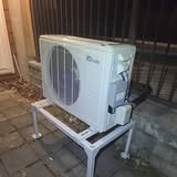 A mini-split outdoor unit on a stand