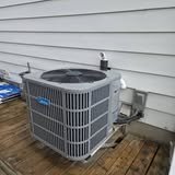 An air conditioner condenser on a deck